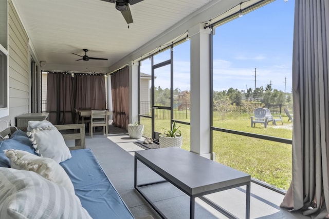 sunroom featuring ceiling fan