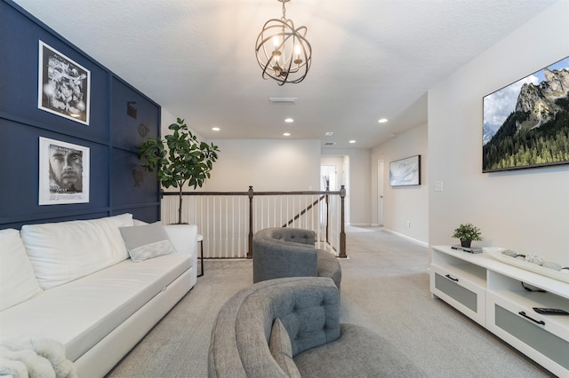 living room featuring a textured ceiling, light colored carpet, and a chandelier