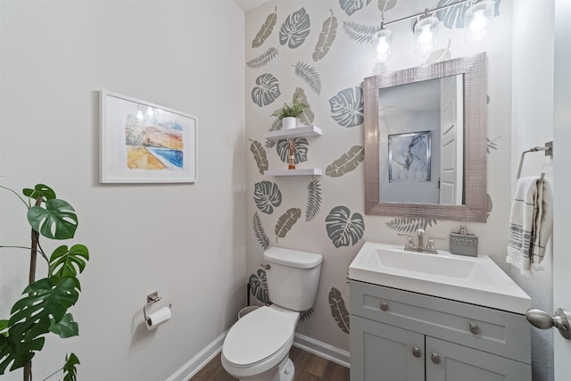 bathroom featuring hardwood / wood-style flooring, vanity, and toilet