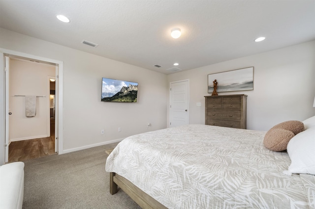 bedroom featuring carpet flooring and connected bathroom