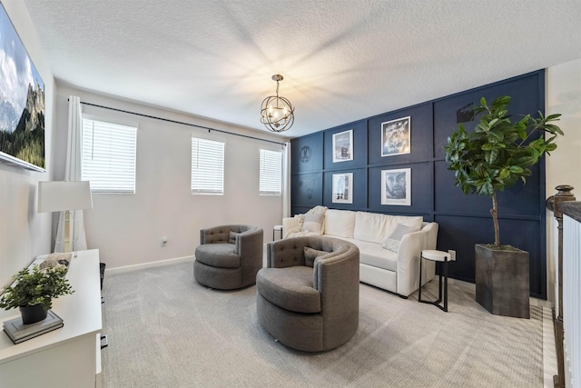 living room with light colored carpet, a textured ceiling, and a notable chandelier