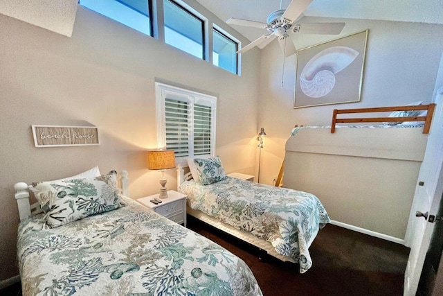 bedroom featuring a towering ceiling and baseboards