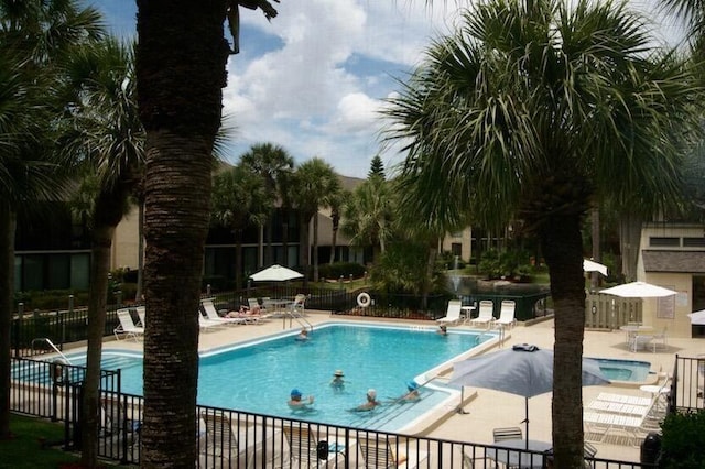 view of swimming pool with a patio area and a jacuzzi