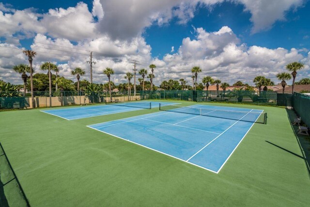 view of tennis court featuring fence