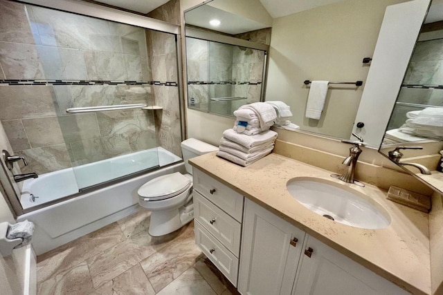 bathroom featuring toilet, enclosed tub / shower combo, and vanity