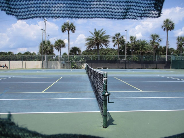 view of sport court featuring fence