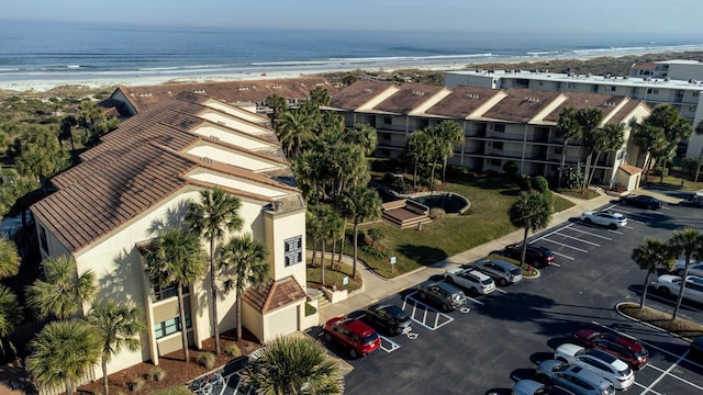 drone / aerial view featuring a beach view and a water view