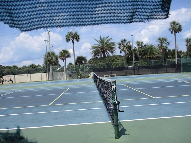 view of tennis court with fence