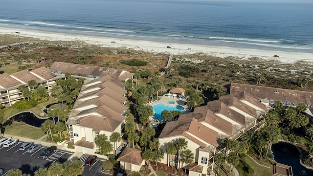 bird's eye view featuring a water view and a beach view