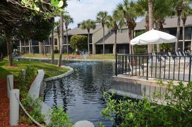 surrounding community featuring a water view and fence