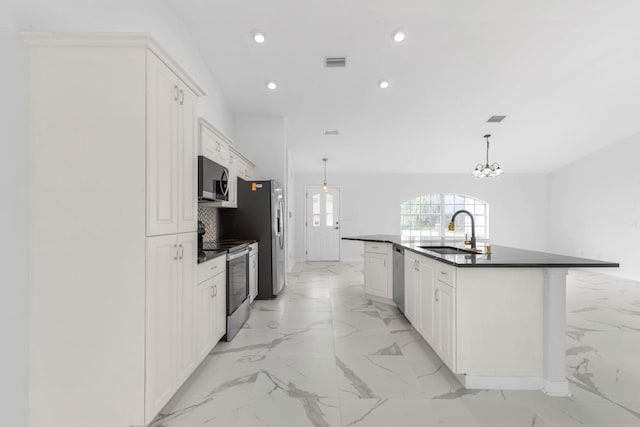 kitchen featuring a sink, marble finish floor, dark countertops, and appliances with stainless steel finishes