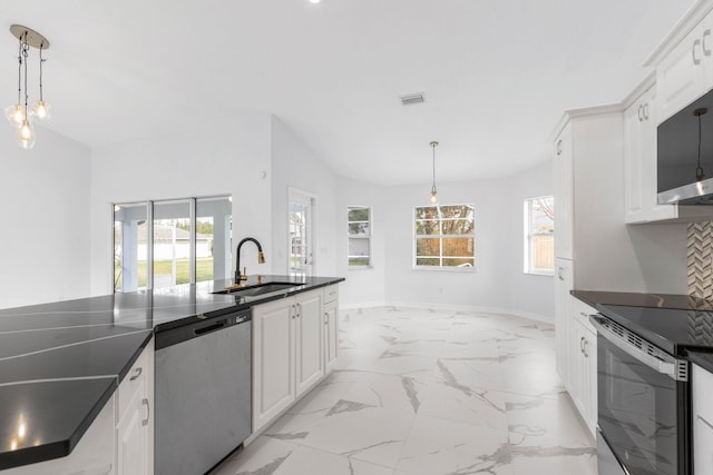 kitchen featuring marble finish floor, a sink, dark countertops, appliances with stainless steel finishes, and white cabinets