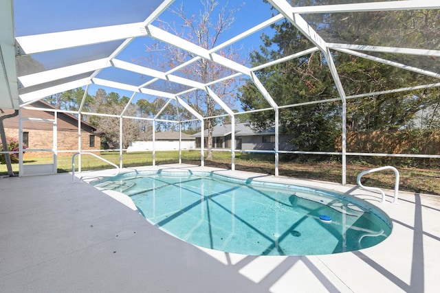 pool featuring glass enclosure and a patio