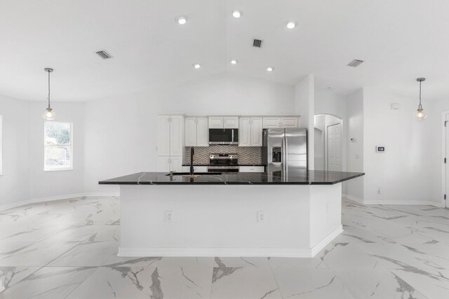 kitchen featuring dark countertops, visible vents, appliances with stainless steel finishes, and tasteful backsplash