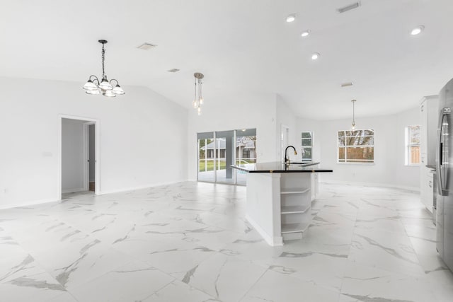 kitchen with visible vents, open shelves, a sink, dark countertops, and open floor plan