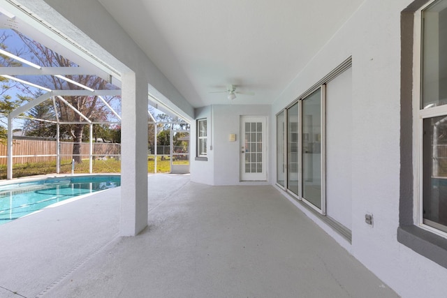 view of pool with a patio, fence, a fenced in pool, ceiling fan, and a lanai