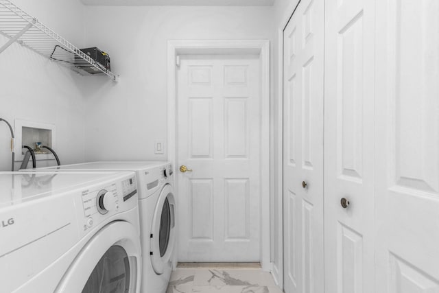 laundry area with marble finish floor, laundry area, and washer and clothes dryer