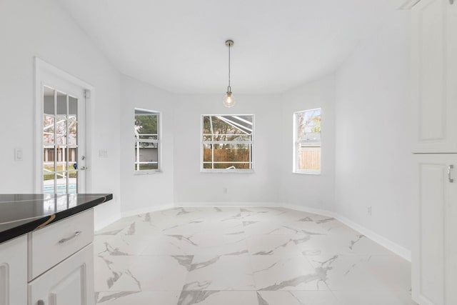 dining area featuring baseboards and marble finish floor