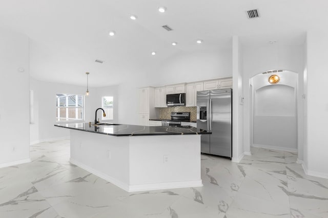 kitchen with visible vents, a sink, stainless steel appliances, dark countertops, and marble finish floor