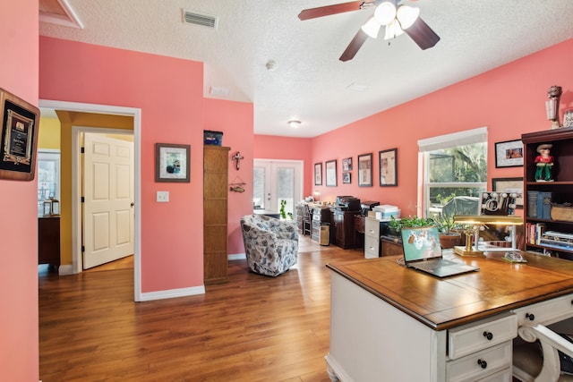 office area featuring wood-type flooring, ceiling fan, a textured ceiling, and french doors