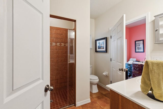 bathroom with walk in shower, vanity, toilet, and tile patterned flooring