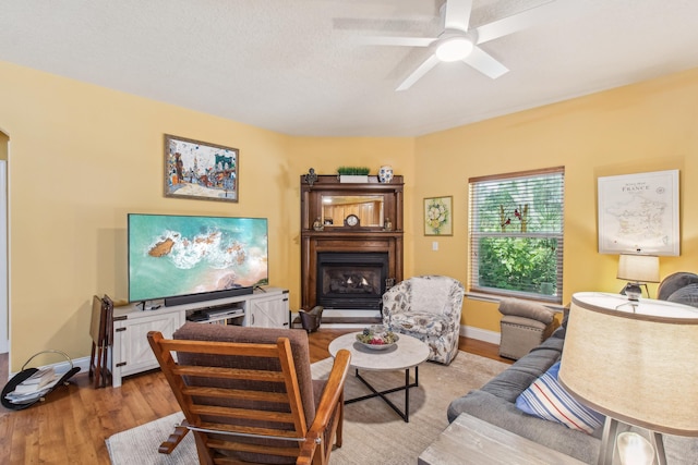 living room with light hardwood / wood-style floors and ceiling fan