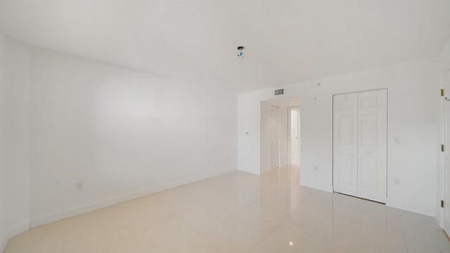 1 John Anderson Dr Unit 218, Ormond Beach, FL 32176 - unfurnished bedroom featuring a closet and light tile patterned floors