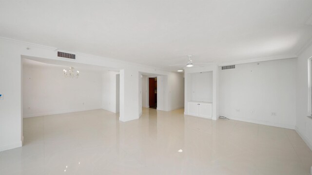 1 John Anderson Dr Unit 218, Ormond Beach, FL 32176 - empty room featuring a ceiling fan, crown molding, a chandelier, light tile patterned floors, and baseboards