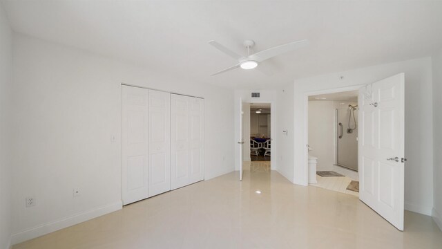 1 John Anderson Dr Unit 218, Ormond Beach, FL 32176 - unfurnished bedroom featuring a closet, connected bathroom, and ceiling fan