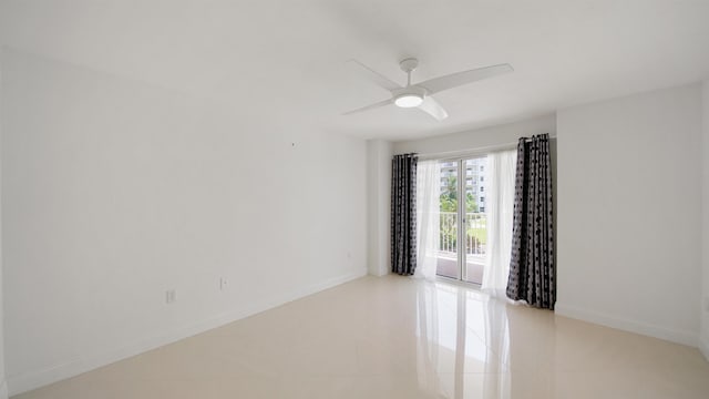 1 John Anderson Dr Unit 218, Ormond Beach, FL 32176 - spare room featuring baseboards, light tile patterned floors, and a ceiling fan