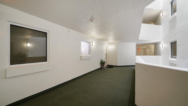 1 John Anderson Dr Unit 218, Ormond Beach, FL 32176 - hallway featuring carpet and baseboards