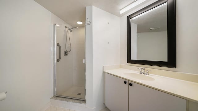 1 John Anderson Dr Unit 218, Ormond Beach, FL 32176 - bathroom with a stall shower, vanity, baseboards, and tile patterned flooring