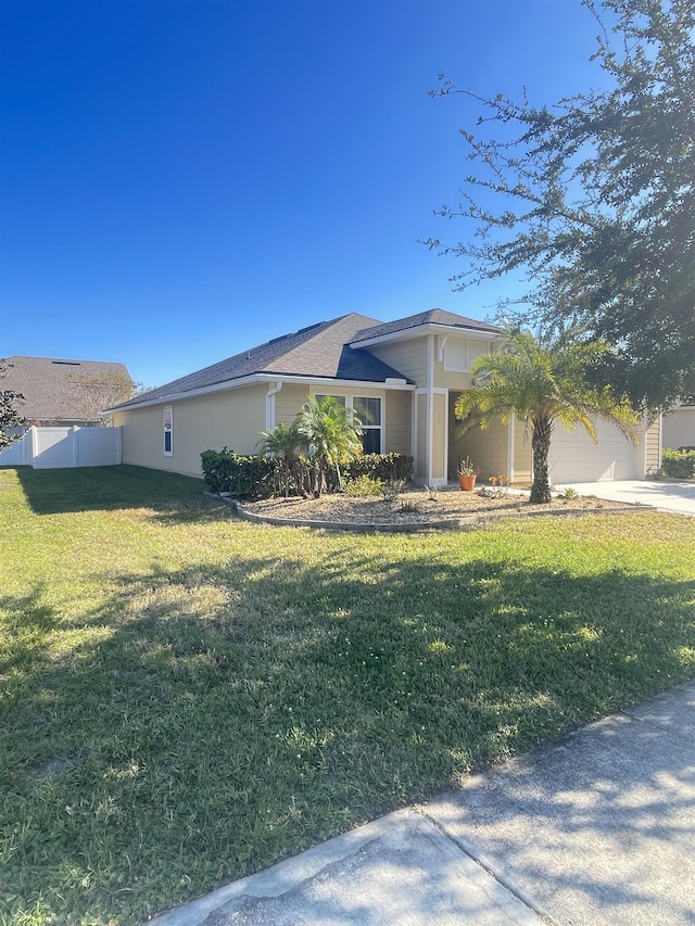 view of side of property featuring a garage and a lawn