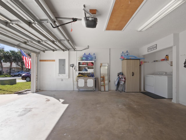 garage with electric panel, a garage door opener, and washing machine and clothes dryer