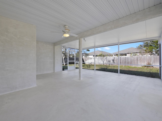 unfurnished sunroom with ceiling fan