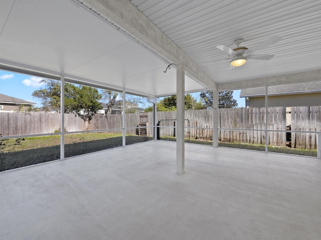 unfurnished sunroom featuring ceiling fan