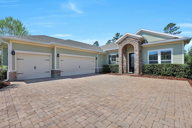 2790 Las Calinas Blvd, Saint Augustine, FL 32095 - single story home featuring stone siding, decorative driveway, an attached garage, and a shingled roof