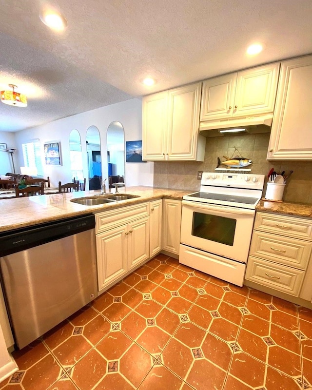 kitchen featuring dishwasher, sink, electric range, a textured ceiling, and tasteful backsplash