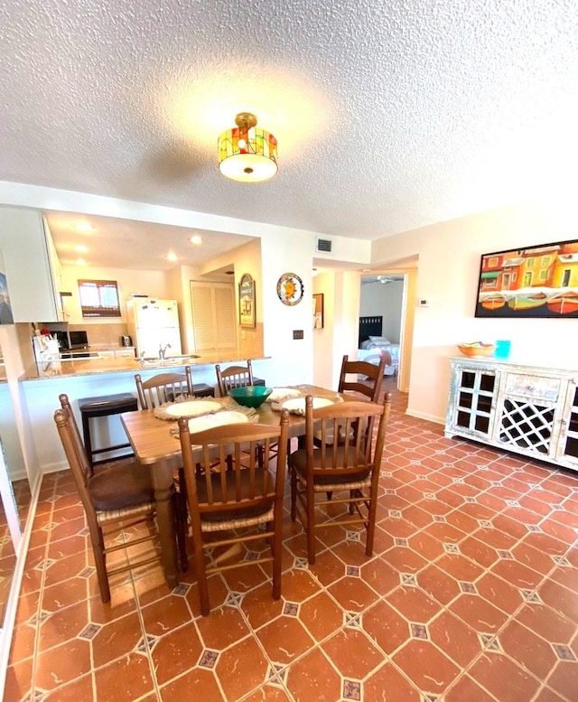 dining room featuring a textured ceiling