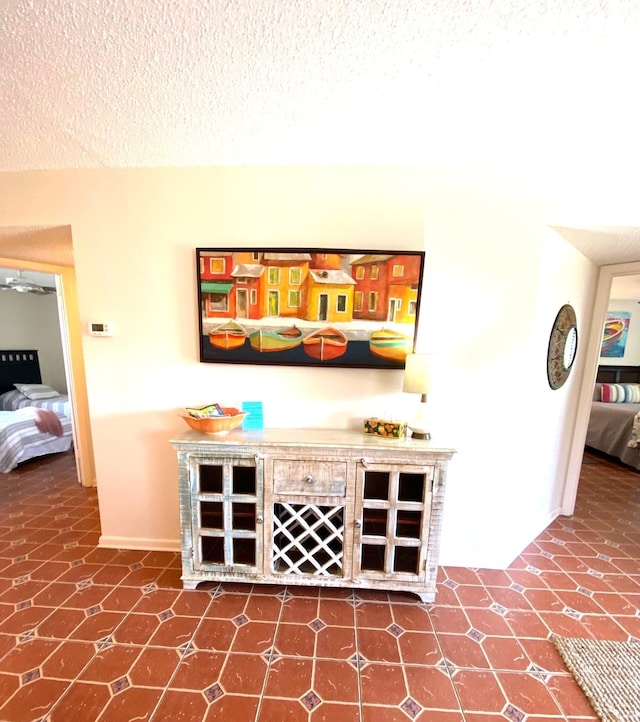 bar featuring tile patterned flooring and a textured ceiling