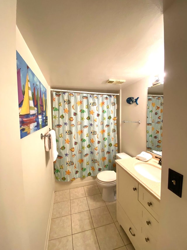 full bathroom with tile patterned floors, vanity, shower / tub combo, and toilet