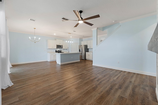 unfurnished living room with ceiling fan with notable chandelier, visible vents, dark wood-type flooring, and ornamental molding