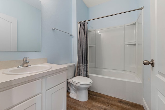 bathroom featuring toilet, wood finished floors, vanity, and shower / bathtub combination with curtain