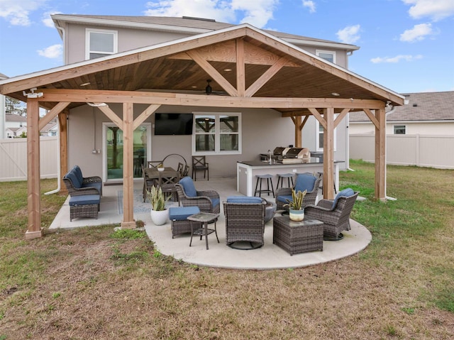 view of patio / terrace with fence, an outdoor hangout area, exterior kitchen, and area for grilling