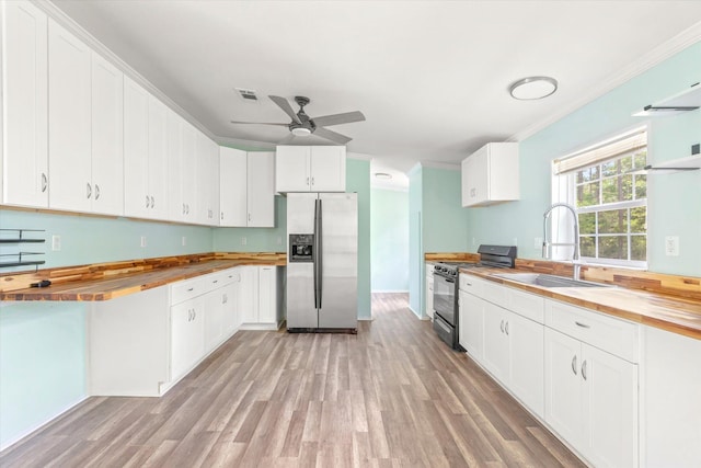10160 Ebert Ave, Hastings, FL 32145 - kitchen featuring stainless steel fridge with ice dispenser, butcher block countertops, gas range, ornamental molding, and a ceiling fan