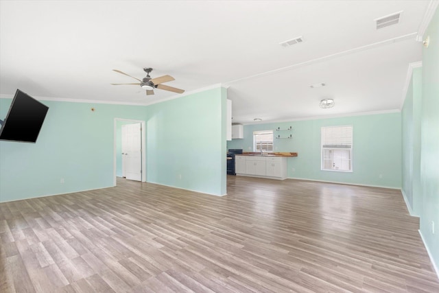 10160 Ebert Ave, Hastings, FL 32145 - unfurnished living room featuring ornamental molding, light wood finished floors, a ceiling fan, and baseboards