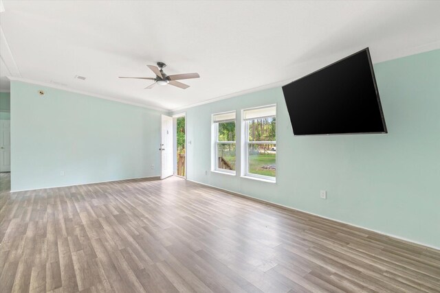 10160 Ebert Ave, Hastings, FL 32145 - unfurnished living room featuring light wood-type flooring, a ceiling fan, and crown molding