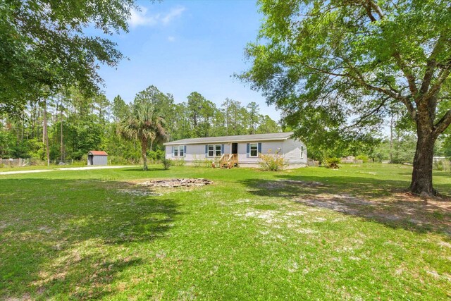 10160 Ebert Ave, Hastings, FL 32145 - view of green lawn featuring a storage shed and an outdoor structure