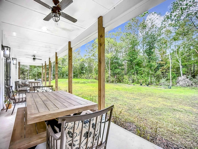 8975 Reid Packing House Rd, Hastings, FL 32145 - view of patio featuring a ceiling fan, outdoor dining space, and view of scattered trees