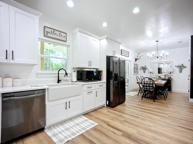8975 Reid Packing House Rd, Hastings, FL 32145 - kitchen with black appliances, a chandelier, light countertops, white cabinets, and recessed lighting